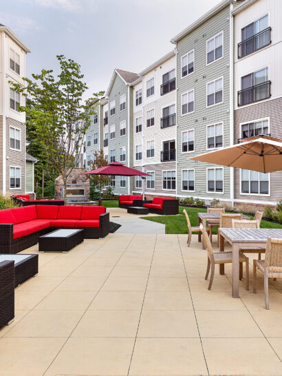 Eli Apartments Courtyard Dining Area with BBQ stations. Dex by Terra commercial design-build project in Sharon, MA.