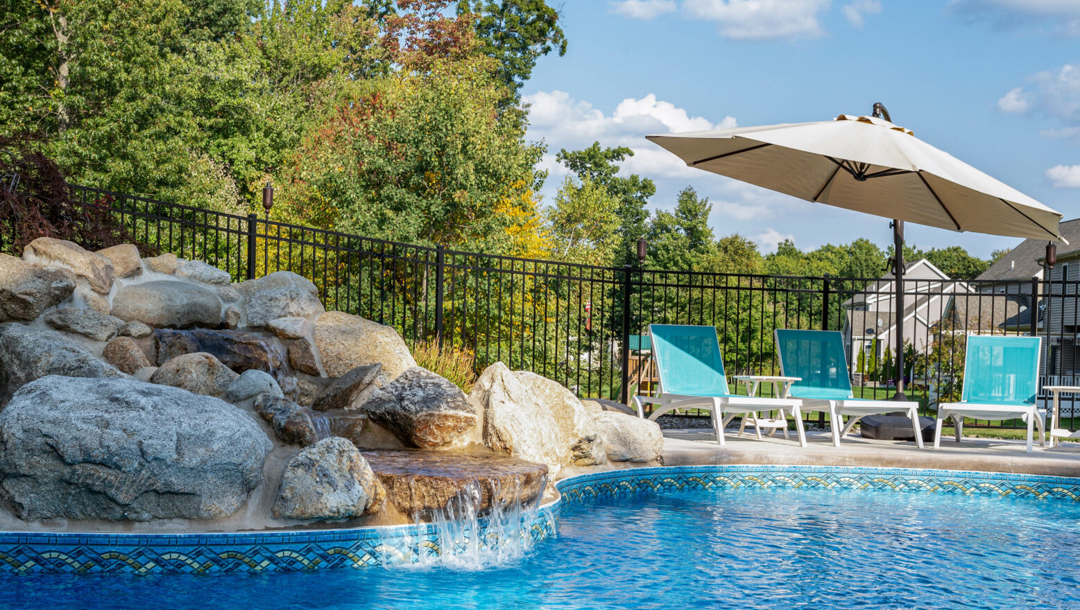 Pool with a water feature made from rocks.