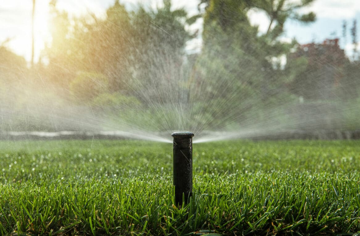 A residential irrigation lawn sprinkler running.