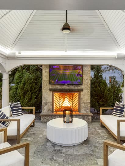 Gazebo patio with stone fireplace and TV. Dex by Terra Landscape design / build project in Andover, Massachusetts.