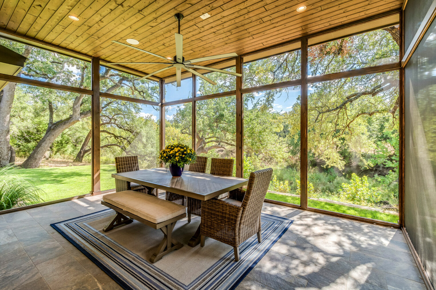 A screened porch in Massachusetts provides a sheltered retreat with scenic backyard views, blending comfort and outdoor beauty.