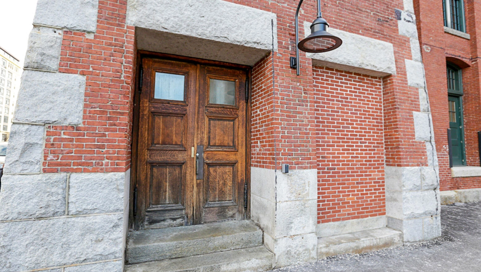 Brick and Stone Exterior Wall with granite headers. Dex by Terra Commercial brick restoration, repointing, & masonry project.