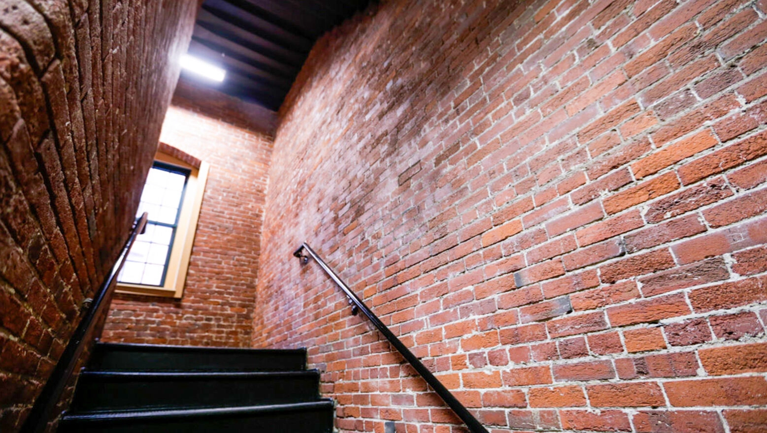 Interior brick stairway at a converted warehouse after restoration & repointing. Dex by Terra Commercial Masonry project.