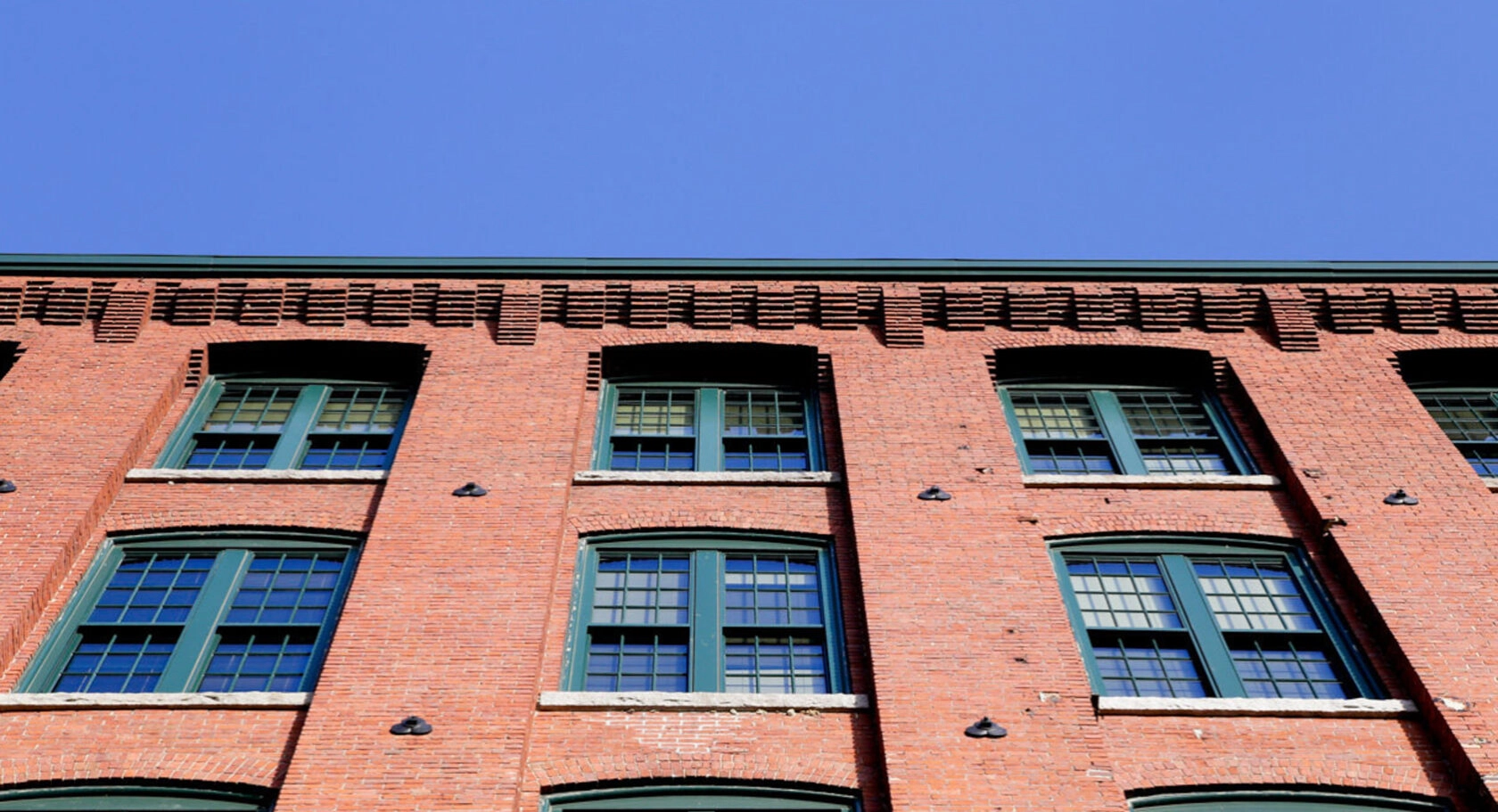 Converted warehouse with brick exterior after restoration & repointing. Dex by Terra Commercial Masonry project in MA.