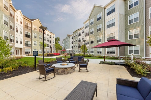 Patio with fire pit and umbrella.
