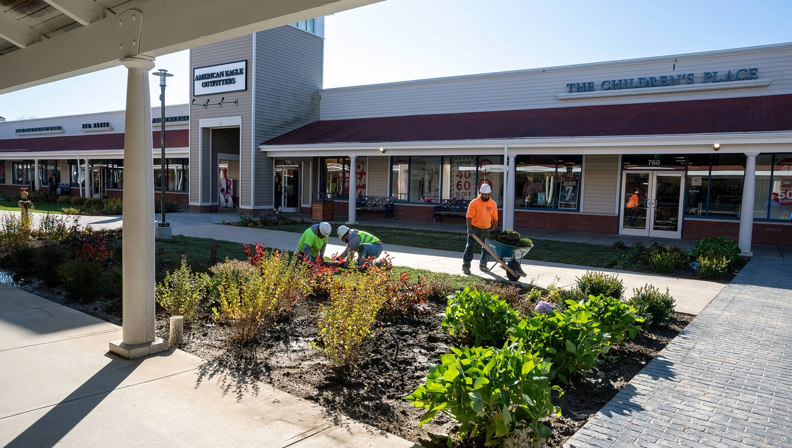 Dex by Terra workers installing landscaping at the Wrentham Outlets in Wrentham, Massachusetts.