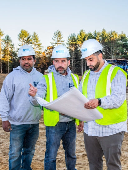 Dex by Terra workers looking at project plans on a commercial job site.