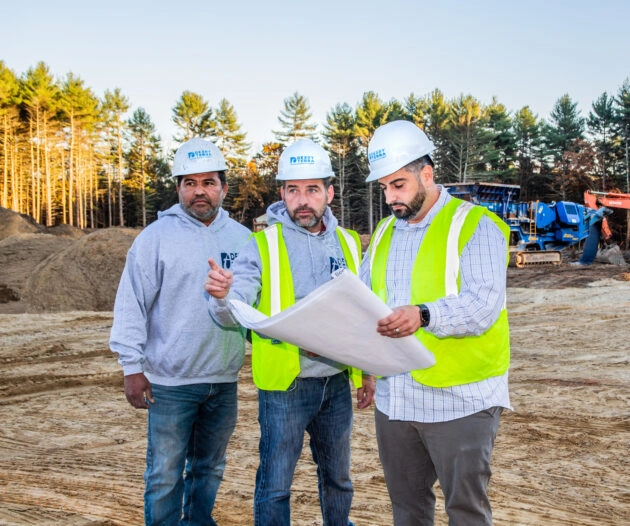 Dex by Terra workers looking at project plans on a commercial job site.