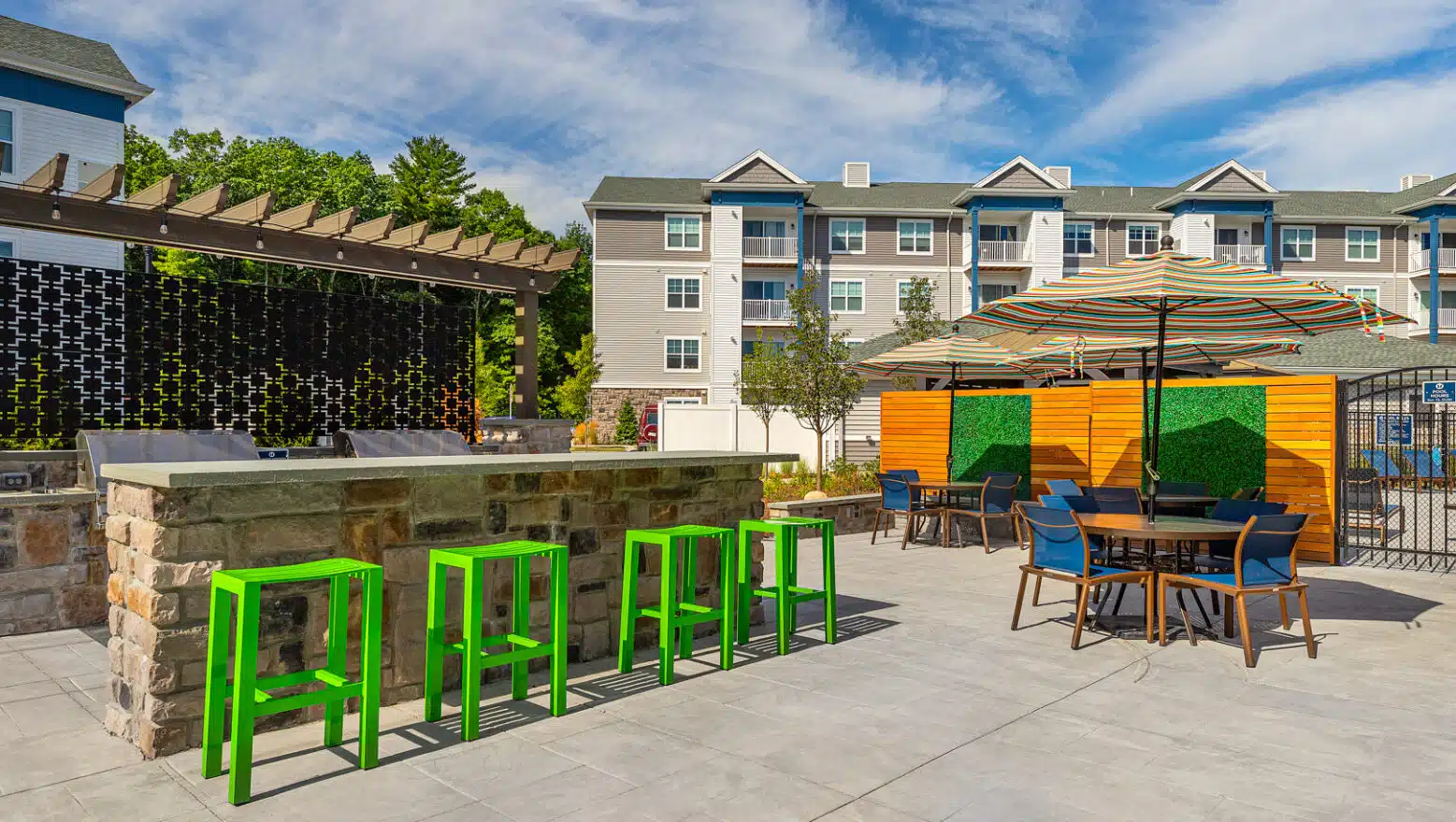 Grill stations & dining area on residential amenity area at Halstead Maynard in Maynard, MA. Dex by Terra Hardscape project.