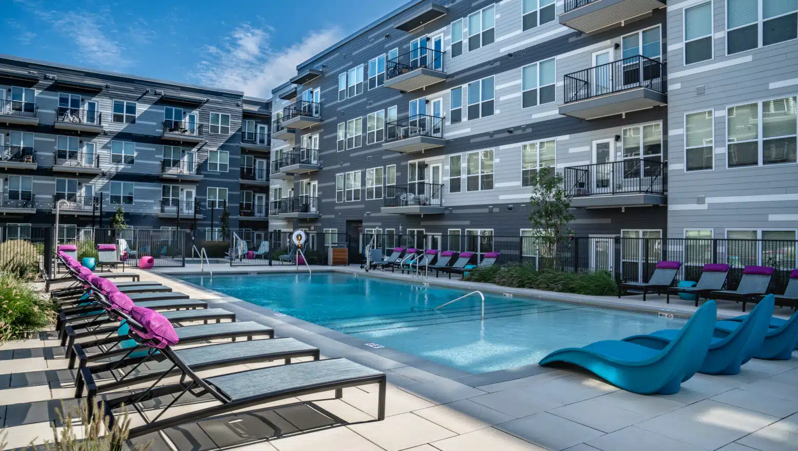Pool area with pool chairs at V2 Apartments in Chelsea, MA. Hardscaping by Dex by Terra of Hudson, MA.